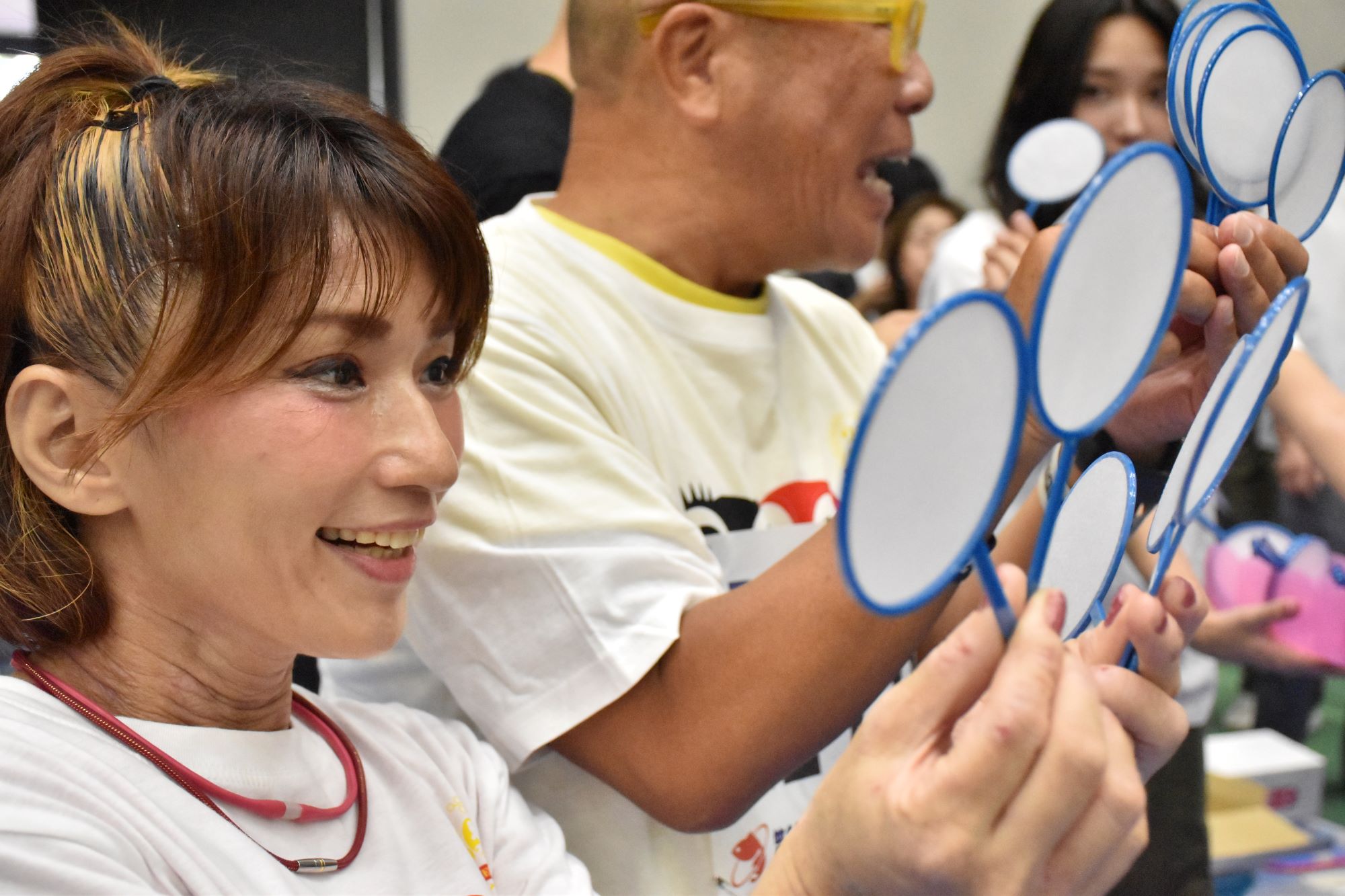 第30回全国金魚すくい選手権大会 総合司会の石原さんが大会に出場しポイを選んでいる様子