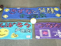 絆と笑顔、頑張ろう日本などの文字の入った編み物の写真