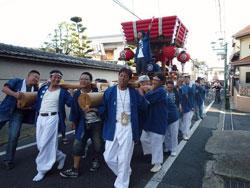 小泉駅前のメインストリート進む大太鼓の様子の写真