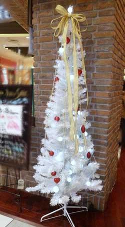 金のリボンがついた白いクリスマスツリーの写真