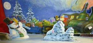 雪だるまとサンタが乗っている汽車が描かれている絵
