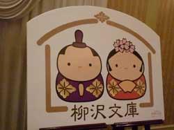 お雛様とお内裏様の丸みを帯びたキャラクターの下に柳澤文庫と書かれたパネルの写真