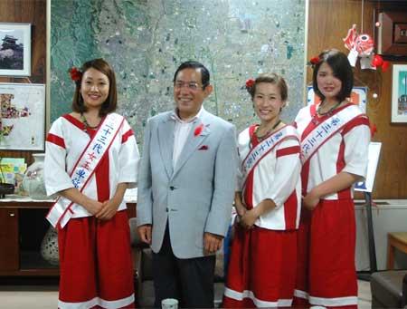 市長と紅白の衣装を身に纏った3人のキャンペーンガールの写真