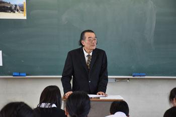 黒板をバックに授業をしている講師の先生の写真