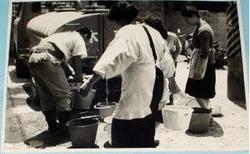 昭和40年に撮影された給水タンク車からの給水を受けている人々の写真