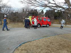 屋外にある消防車と消防団員たちの写真